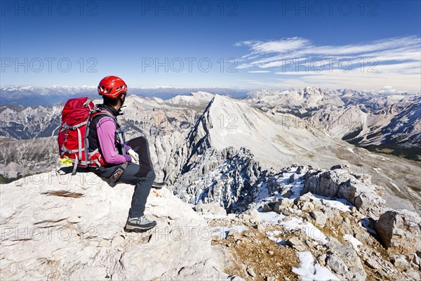 Mountain climber on the peak of Zehnerspitze Mountain in the Fanes Group