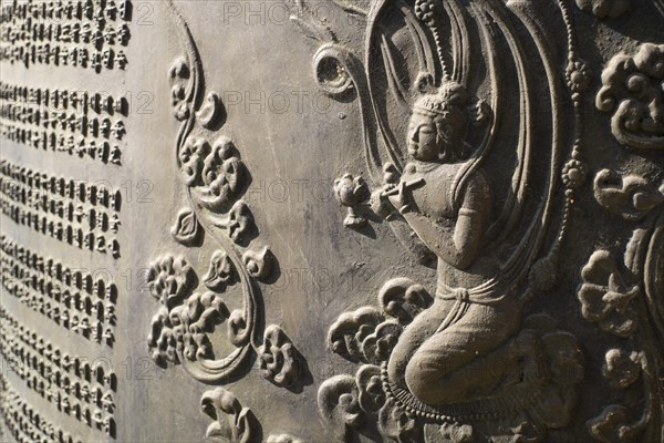 Relief in an ancient bronze bell at Chokseongnu Pavilion