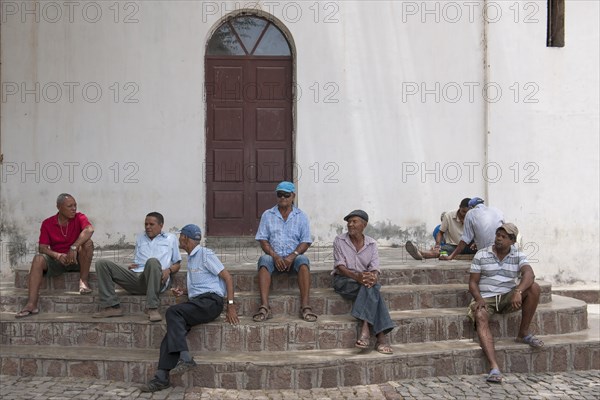 Men meeting on the steps of the church Cha de Igreja