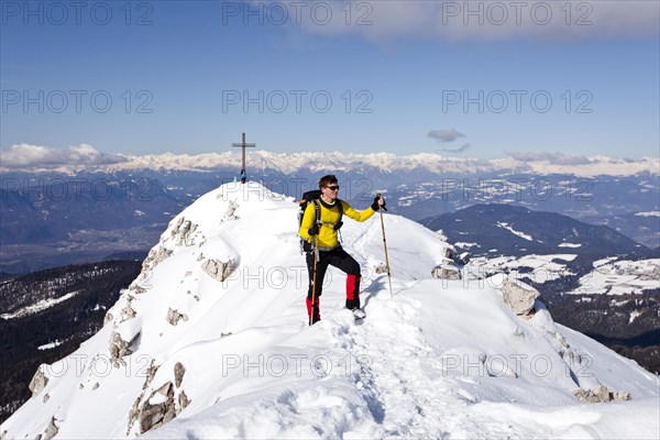 Winter hiker on the summit ridge while descending from Weisshorn Mountain on Jochgrimm Pass