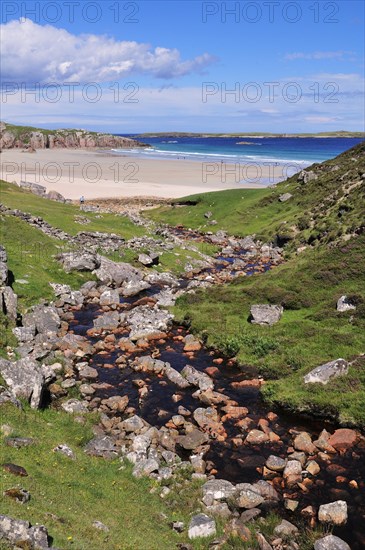 The Allt Chailgeag stream transporting brown bog water into Rispond Bay