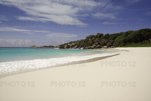 Sandy beach with the rock formations typical for the Seychelles