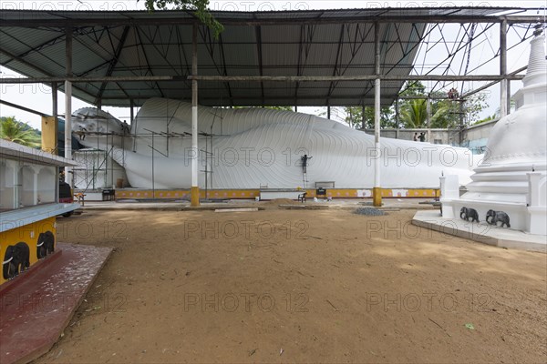 Reclining Buddha being restored