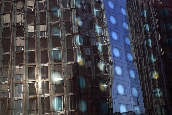 Tanzende Turme office building reflected in the facade of the Arcotel Onyx Hotel