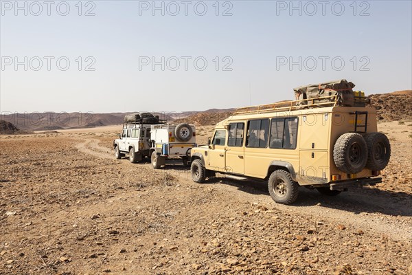 Land Rovers travelling on a dirt track