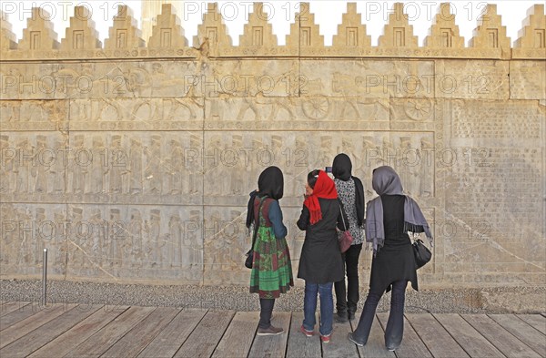 Local tourists looking at a bas-relief