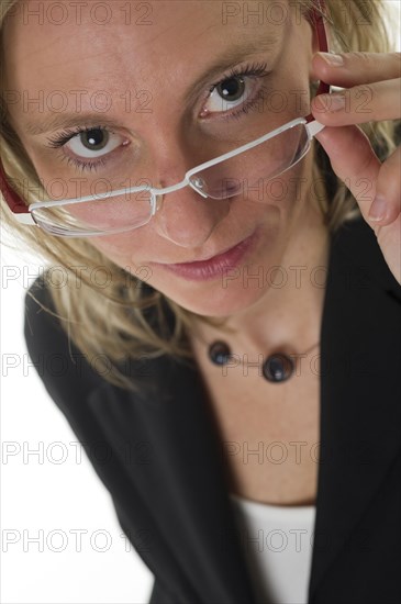 Business woman peering over the edge of her glasses