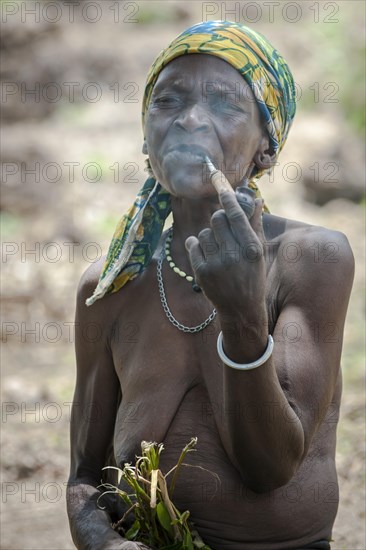 A woman from the Koma people smoking a pipe