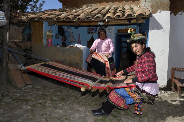 Young woman weaving traditional cloth at the loom