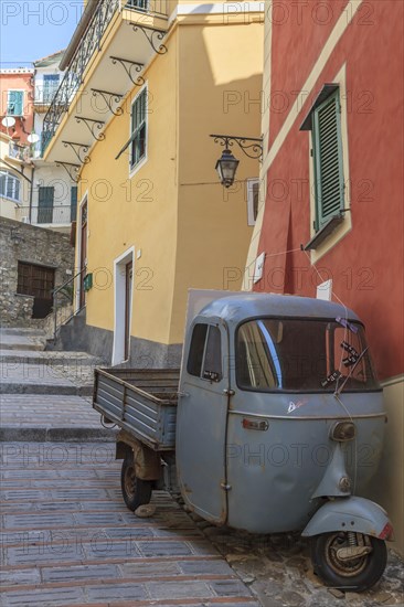 Typical Italian three-wheeled light commercial vehicle parked in an alley