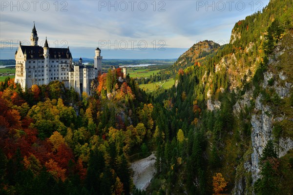 Schloss Neuschwanstein Castle in autumn as seen from Marienbruecke bridge