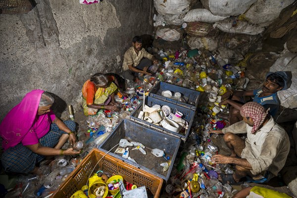 Workers sorting out plastic garbage for recycling