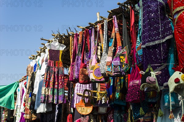 Colourful clothes and bags for sale at the weekly flea market