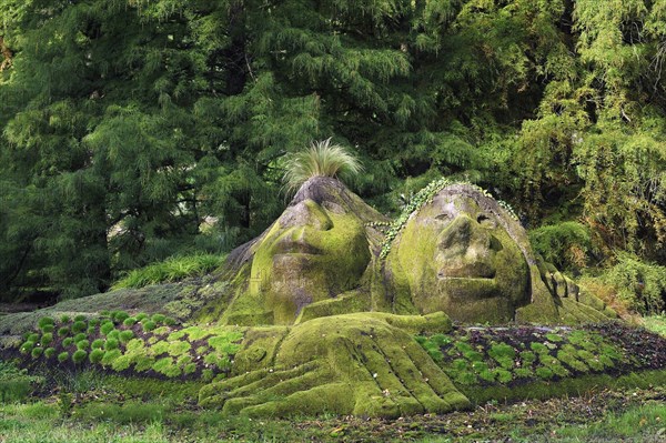 Stone statues overgrown with moss