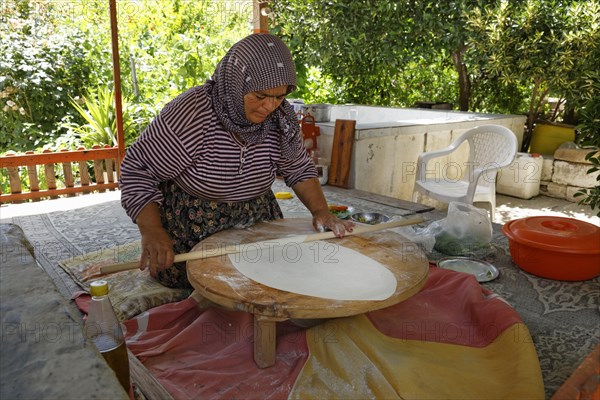 Woman rolling dough for Goezleme flatbread