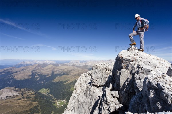 Mountain climber on the summit of Cima di Vezzana Mountain
