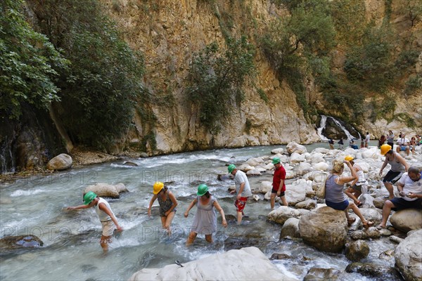 Tourists crossing the river