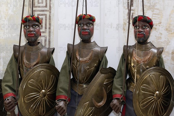 Three dark-skinned Moor-warriors in armour