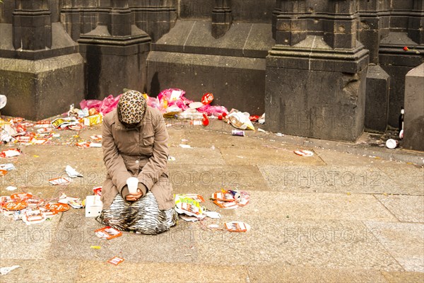 Female beggar on Domplatte square