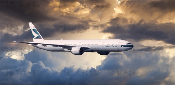 Cathay Pacific Boeing 777-367 ER in flight in the evening light