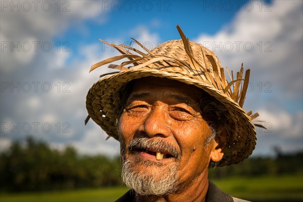 Elderly rice farmer wearing a straw hat