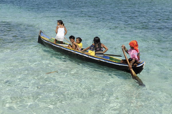 Kuna Indians in a dugout canoe