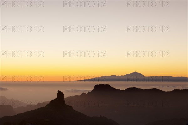 Rock formation of Roque Bentayga in front of Tenerife with Mount Teide