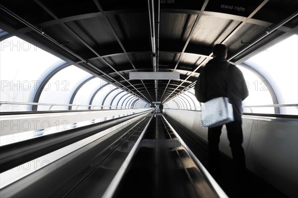 Moving sidewalk in oval tunnel connecting exhibition halls on fair ground