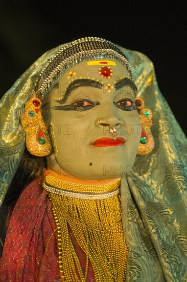 Kathakali dancer in full makeup wearing a costume