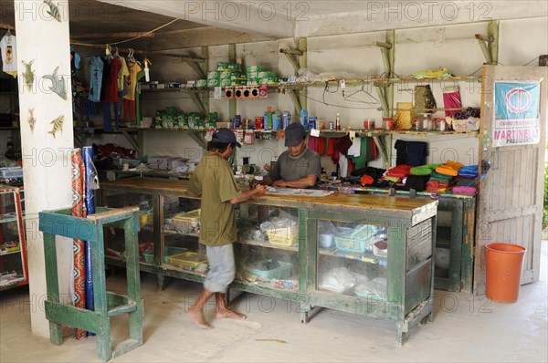 Kuna Indian men in a store in a Kuna Indian village