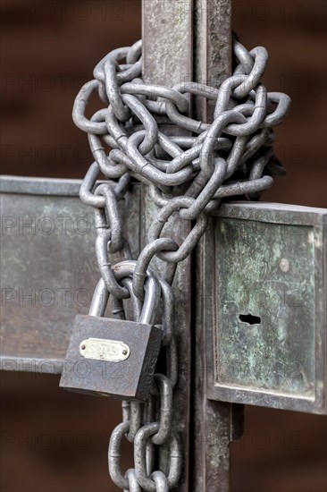 Chain with padlock on an iron gate