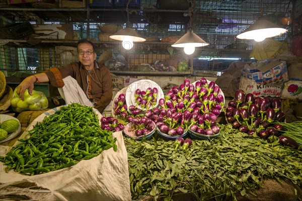 Man selling vegetables at a vegetable market