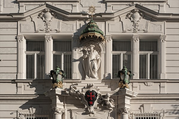 Sculpture with a baldachin or canopy and a red star above the entrance portal of the building of the 'Knightly Order of Knights of the Cross with the Red Star'