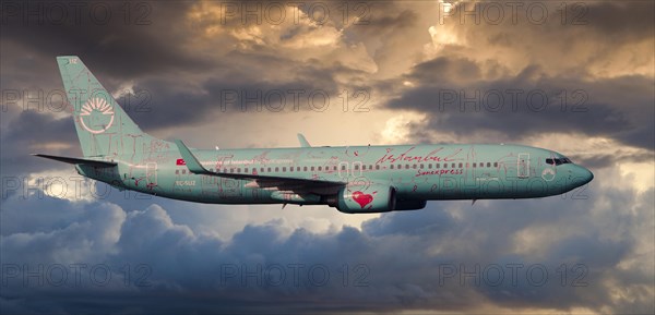 SunExpress Boeing 737 in flight in the evening light