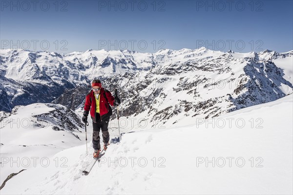 Ski tourer standing on the summit ridge of Laaser Spitze mountain