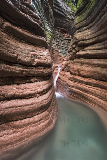 The Taugl river flowing through a red gorge