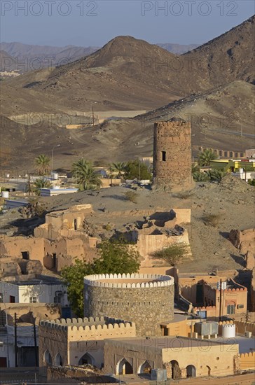 Houses and old watch tower at the edge of the Wahiba Sands desert