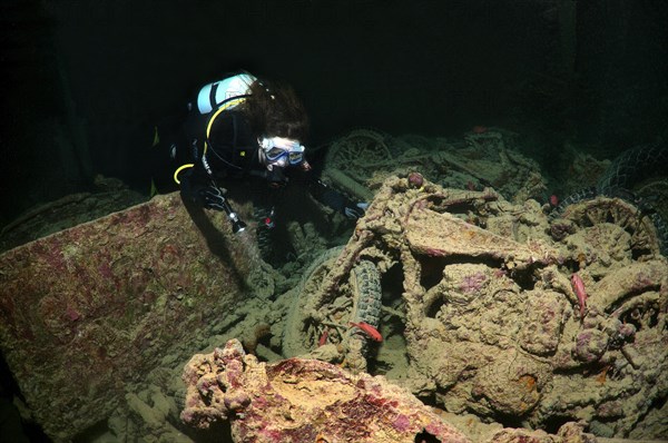 Scuba diver looking at Norton 16H motorcycle