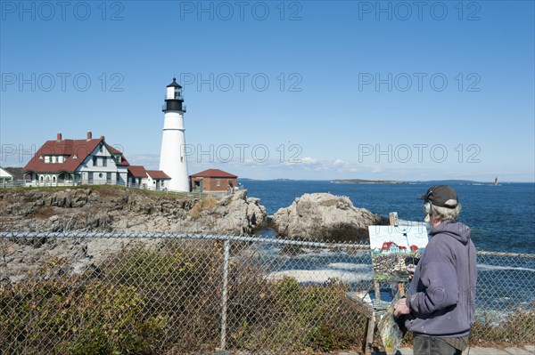 Painter painting a lighthouse