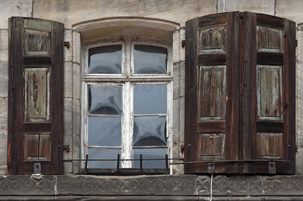 Window with shutters on a town house