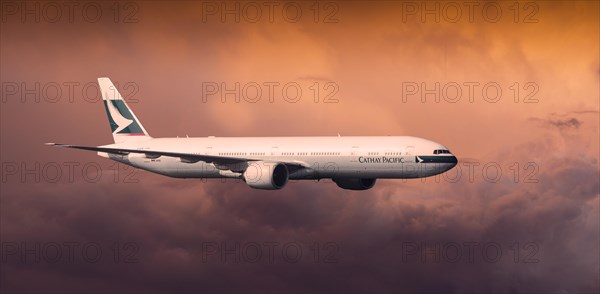 Cathay Pacific Boeing 777-367 ER in flight in the evening light