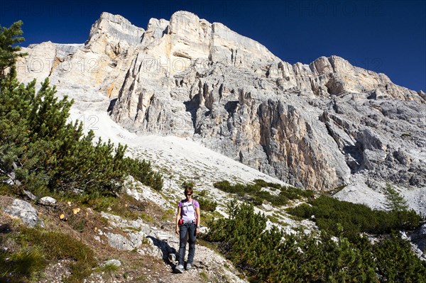 Mountain climber descending the Heiligkreuzkofelsteig climbing route on Heiligkreuzkofel Mountain in the Fanes Group