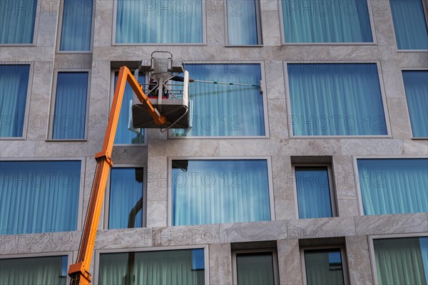 Window cleaner cleaning the windows of a hotel