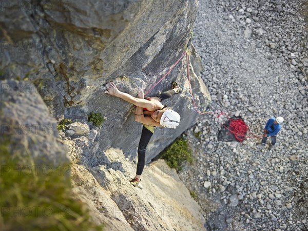 Woman lead climbing a ledge