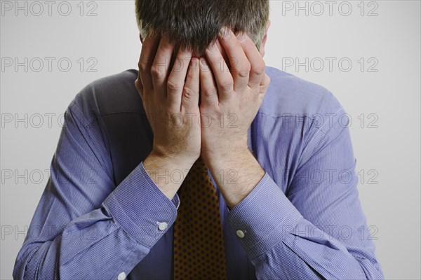 Businessman with his head in his hands