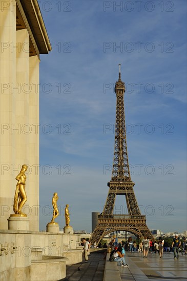 Golden statues at the Palais de Chaillot with the Eiffel Tower