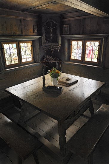 Herrgottswinkel prayer niche with a table and benches in Markus Wasmeier Farm and Winter Sports Museum