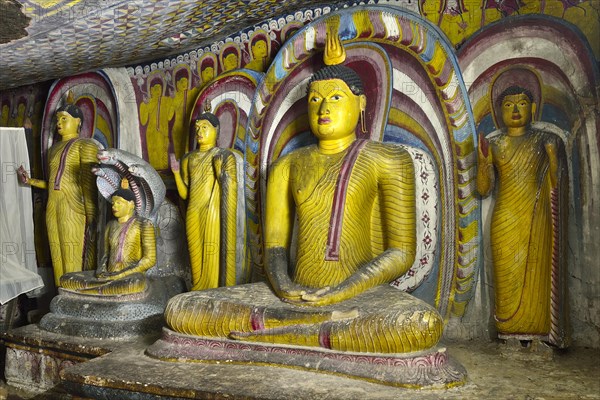 Buddha statues and murals in one of the cave temples of the Golden Temple