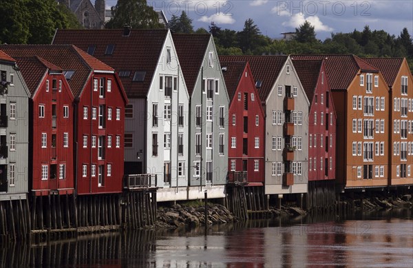 Colourful wooden houses on stilts on the Nidelv River