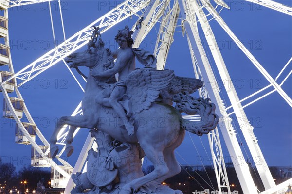 Sculpture in front of a ferris wheel